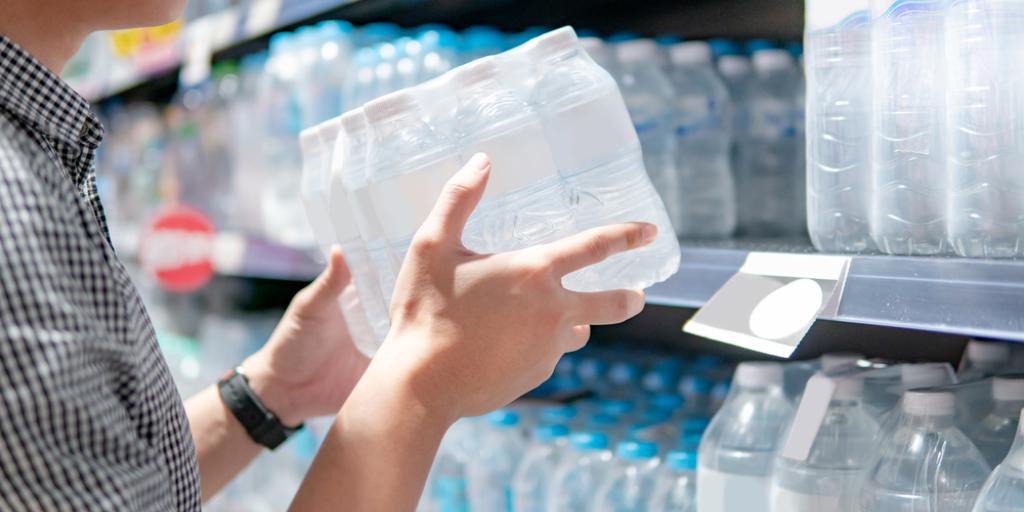A man in a store buying bottled water
