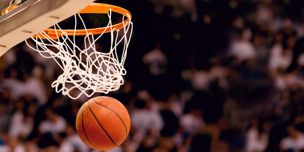 A basketball going through a net