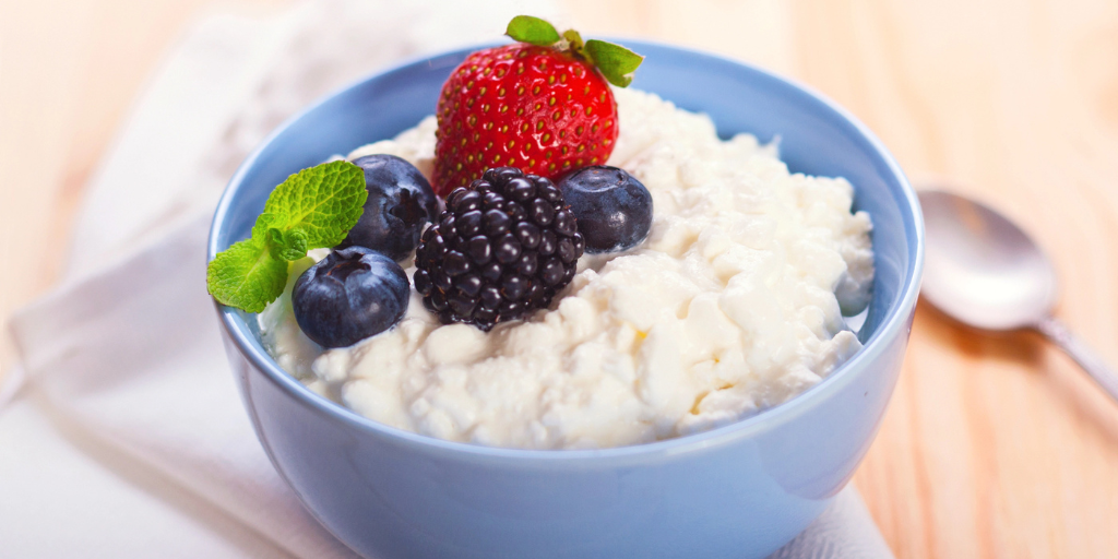 A bowl of cottage cheese with fruit on top
