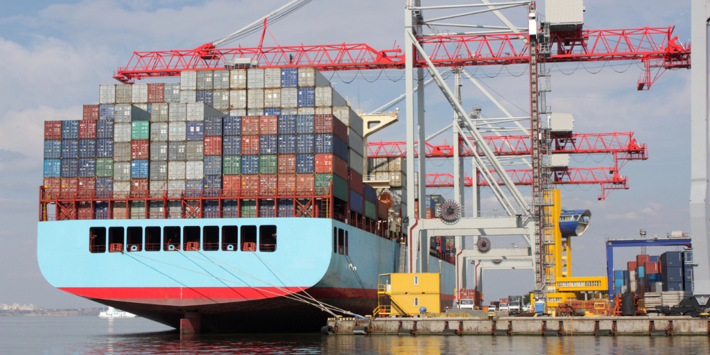A large container ship waiting to be unloaded at a port